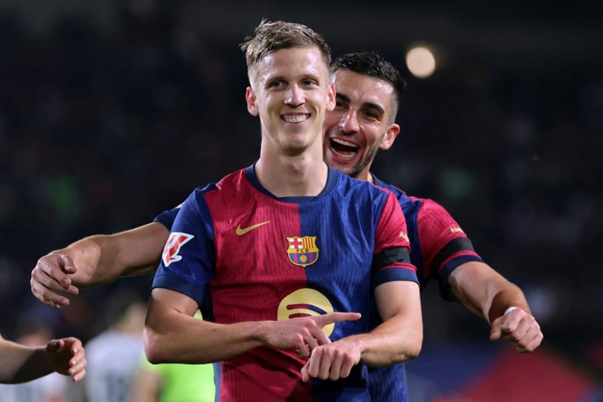 Barcelona's Spanish forward #20 Daniel Olmo (Front) celebrates with his teammate Barcelona's Spanish forward #07 Ferran Torres after scoring a penalty kick and his team's second goal during the Spanish league football match between FC Barcelona and CA Osasuna at Estadi Olimpic Lluis Companys in Barcelona on March 27, 2025. LLUIS GENE / AFP