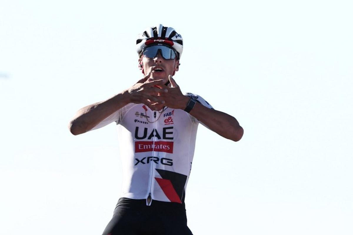 UAE Team Emirates XRG Switzerland's Jan Christen celebrates his victory as he crosses the finish line of the fifth and last stage of the AlUla Tour cycling race, 163.9km from Alula Old Town to Skyviews of Harrat Uwayrid on January 31, 2026. Anne-Christine POUJOULAT / AFP