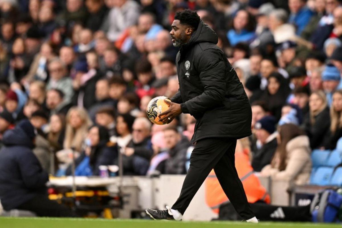 Manchester City's Ivorian assistant coach Kolo Touré holds the ball during the English FA Cup third round football match between Manchester City and Salford City at the Etihad Stadium in Manchester, north west England, on February 14, 2026. Oli SCARFF / AFP