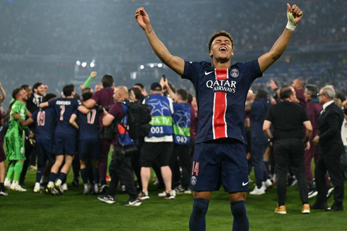 Paris Saint-Germain's French midfielder #14 Desire Doue (R) celebrates winning the UEFA Champions League final football match between Paris Saint-Germain (PSG) and Inter Milan in Munich, southern Germany, on May 31, 2025. INA FASSBENDER / AFP