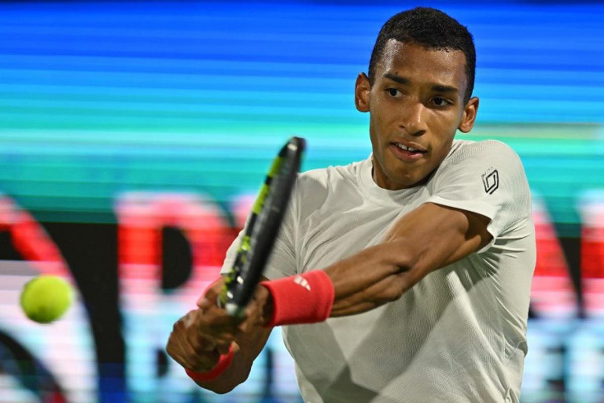 Canada's Felix Auger Aliassime returns the ball to Greece's Stefanos Tsitsipas during the final match of the ATP Dubai Duty Free Tennis Championship in Dubai on March 1, 2025. Ryan Lim / AFP
