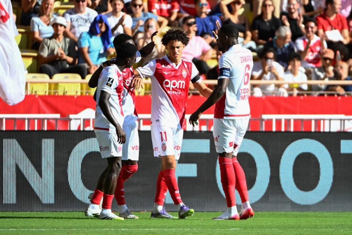 Monaco's French midfielder #11 Maghnes Akliouche (C) celebrates scoring his team's first goal during the French L1 football match between AS Monaco and RC Strasbourg Alsace at the Louis II Stadium in the Principality of Monaco on August 31, 2025. FREDERIC DIDES / AFP