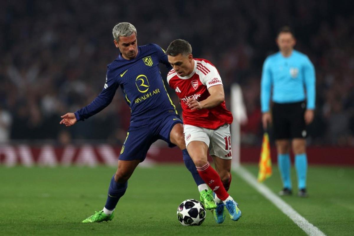 Atletico Madrid's French striker #07 Antoine Griezmann battles for the ball with Arsenal's Belgian midfielder #19 Leandro Trossard during the UEFA Champions League second-leg semi-final football match between Arsenal and Atletico Madrid at the Emirates Stadium in north London on May 5, 2026. Adrian Dennis / AFP