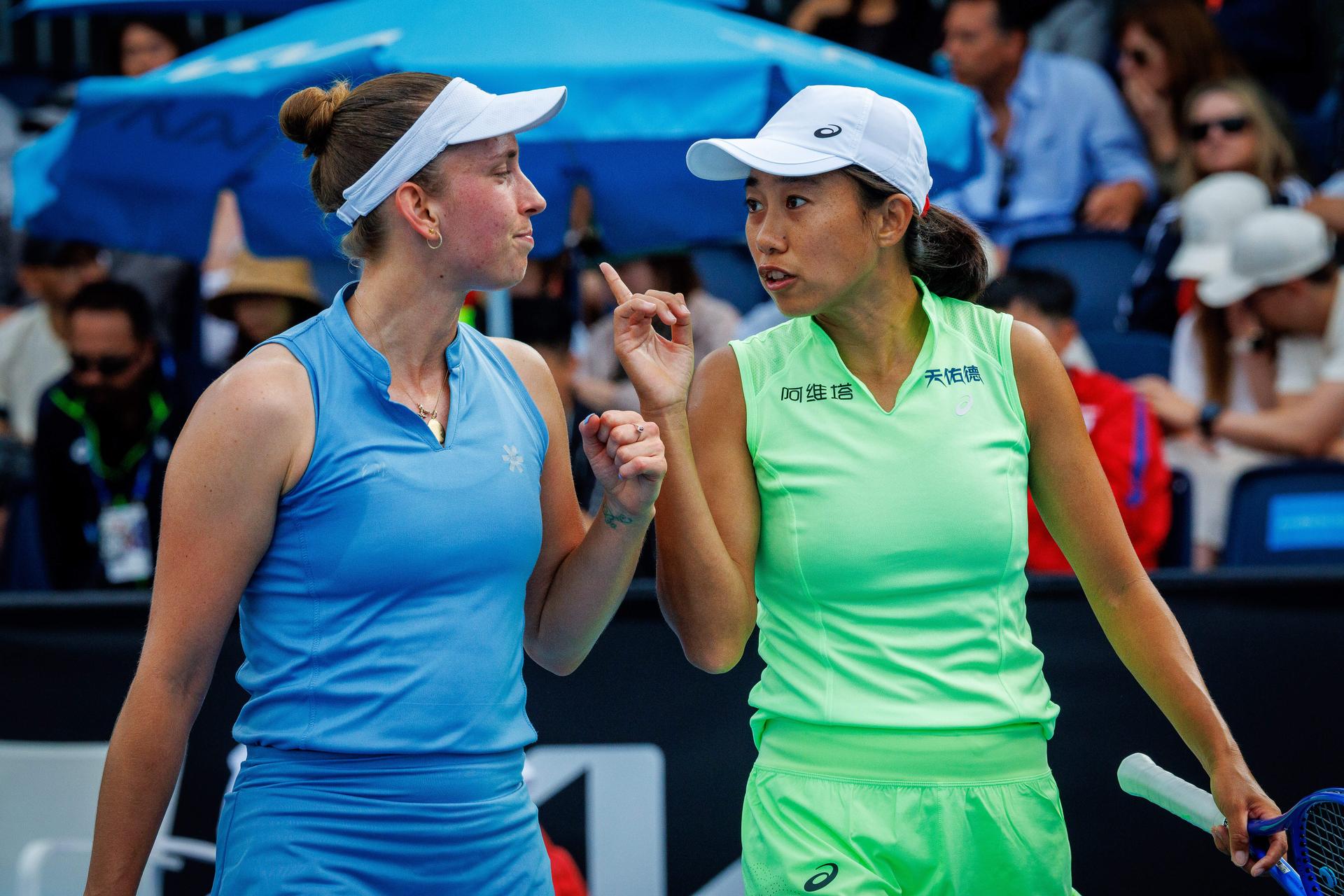 Belgian Elise Mertens (blue, L) and Chinese Zhang Shuai (green) pictured during during a first round match of Belgium-China's Mertens-Shuai pair against Romania-Russia's pair Cirstea-Kalinskya in the women doubles at the Australian Open, Melbourne Park, Melbourne on Wednesday 21 January 2026. Mertens - Shuai won the game. BELGA PHOTO PATRICK HAMILTON --- BENELUX ONLY ---