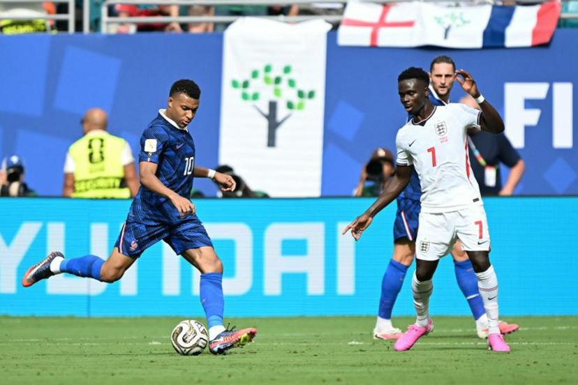France's forward #10 Kylian Mbappe and England's forward #07 Bukayo Saka fight for the ball during the 2026 World Cup football tournament third-place match between France and England at the Miami Stadium in Miami on July 18, 2026. CHANDAN KHANNA / AFP