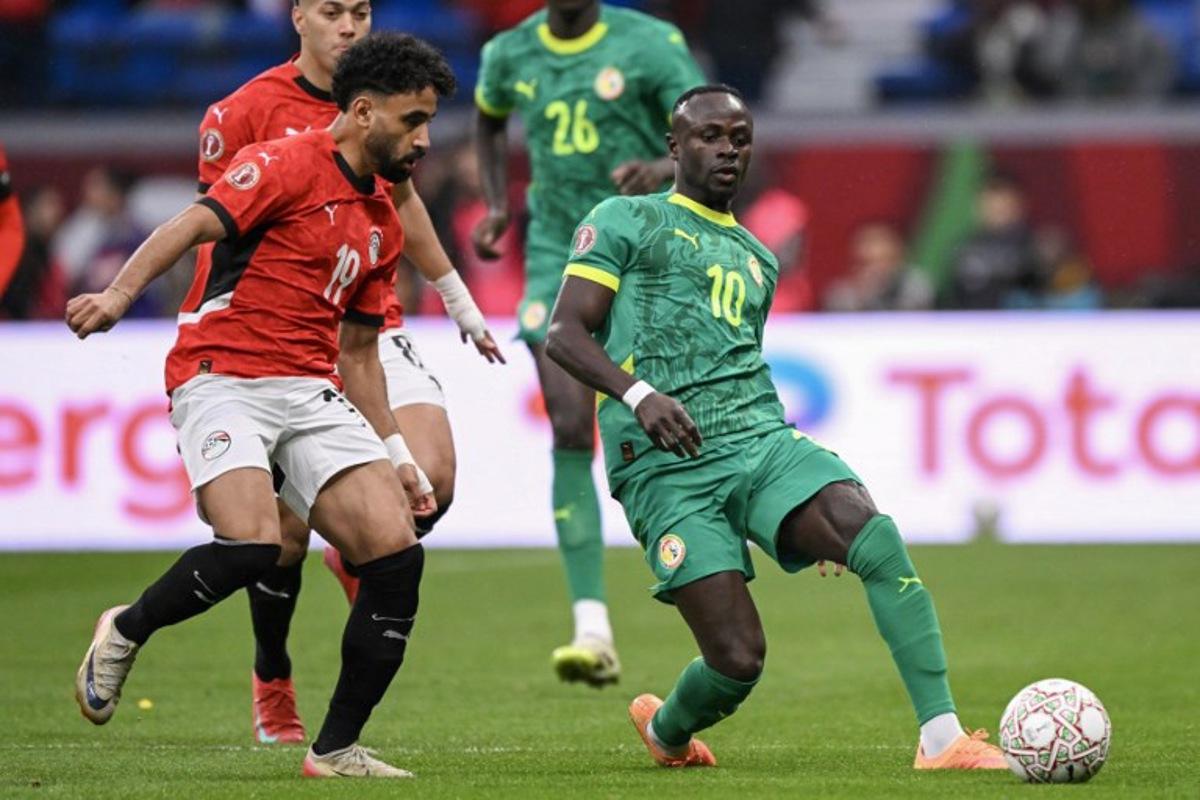 Egypt's midfielder #19 Marwan Ateya and Senegal's forward #10 Sadio Mane vie during the Africa Cup of Nations (CAN) semi-final football match between Senegal and Egypt at the Grand stadium in Tangiers on January 14, 2026. SEBASTIEN BOZON / AFP