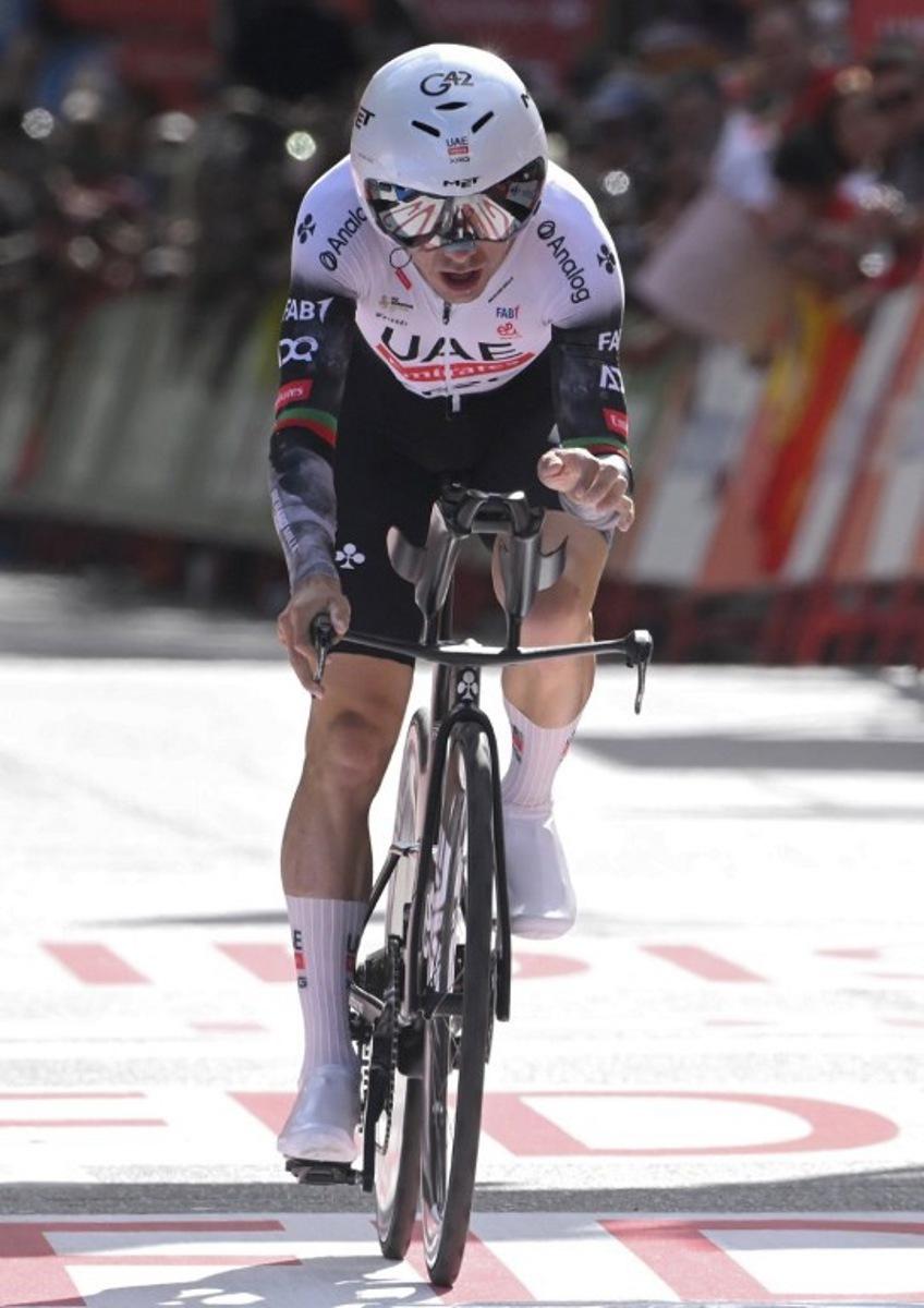 Team UAE's Portuguese rider Joao Almeida crosses the finish line of the 18th stage of the Vuelta a Espana, a 26 km race against the clock between Valladolid and Valladolid, on September 11, 2025. Miguel RIOPA / AFP