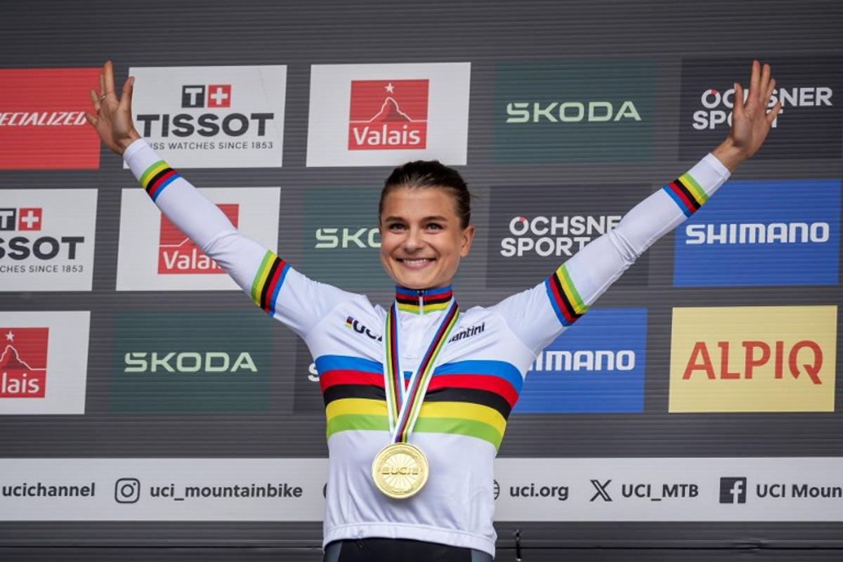 Sweden's Jenny Rissveds celebrates with her gold medal during the podium ceremony of the Women's elite Cross-country Olympic race as part of the 2025 UCI Mountain Bike World Championships in Crans-Montana on September 13, 2025. Fabrice COFFRINI / AFP
