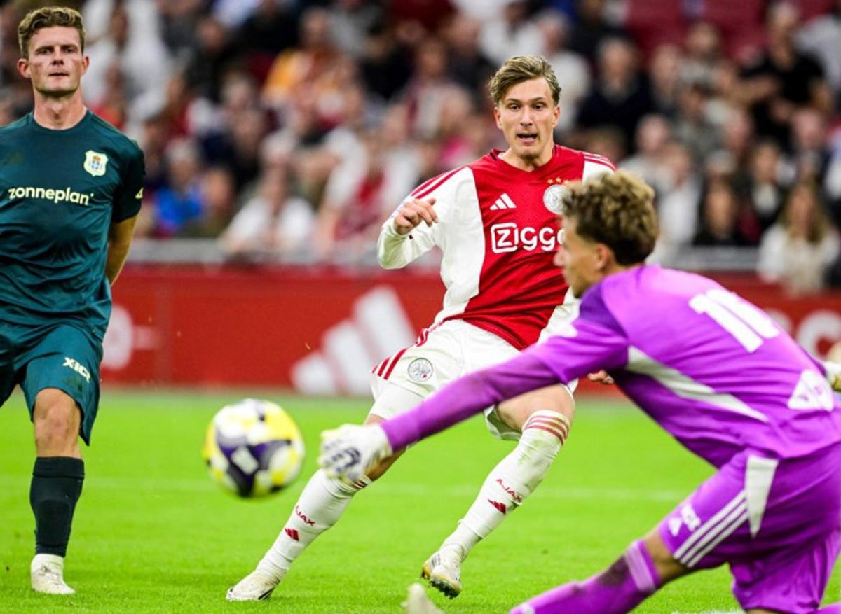 Ajax's Belgian forward #11 Mika Godts (C) eyes the ball during the Dutch Eredivisie football match between Ajax Amsterdam and and PEC Zwolle at the Johan Cruijff ArenA in Amsterdam on September 13, 2025. Olaf Kraak / ANP / AFP