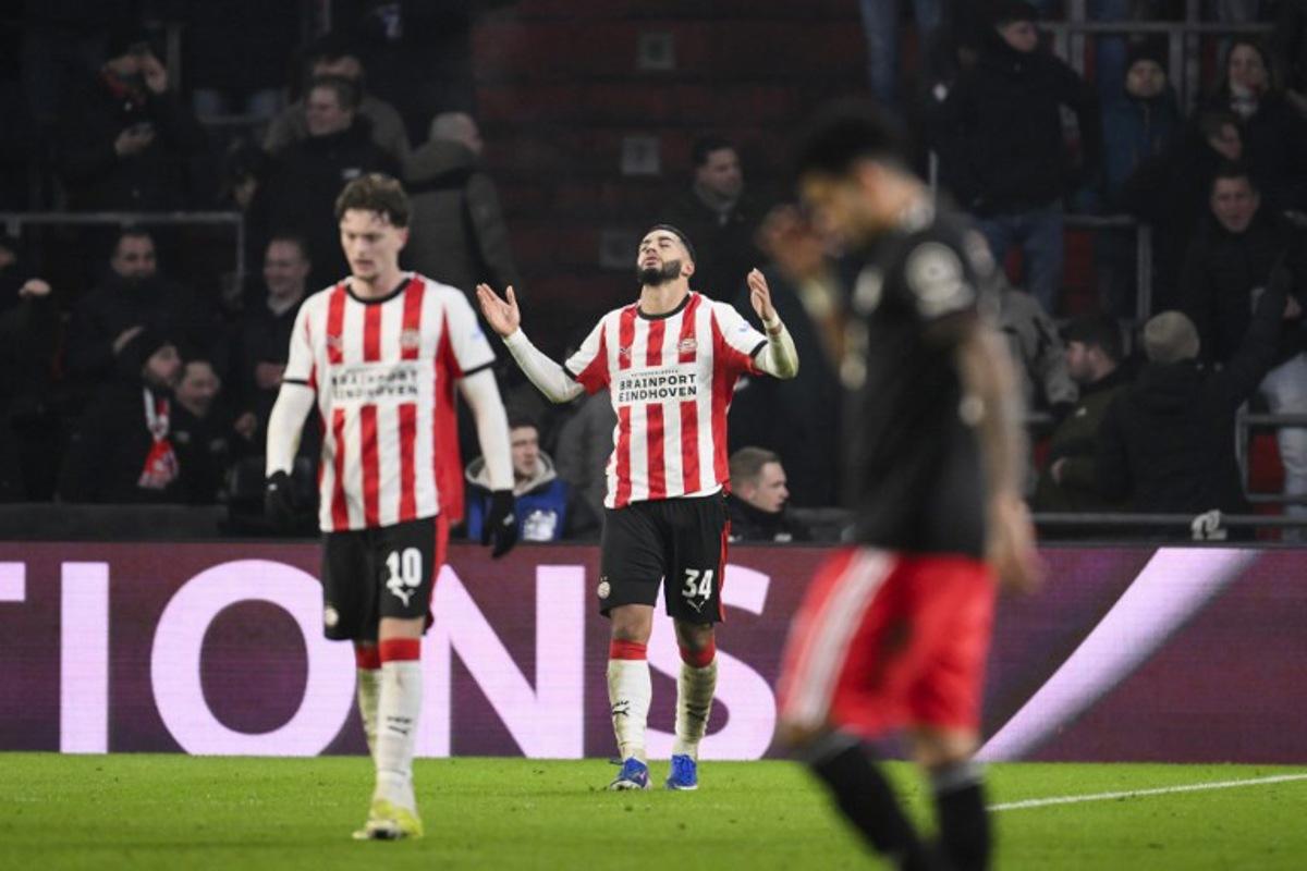 PSV Eindhoven's Moroccan midfielder #34 Ismael Saibari (C) celebrates after scoring his team's first goal during the UEFA Champions League league phase day 8 football match between PSV Eindhoven and Bayern Munich at Philips Stadion in Eindhoven on January 28, 2026. JOHN THYS / AFP