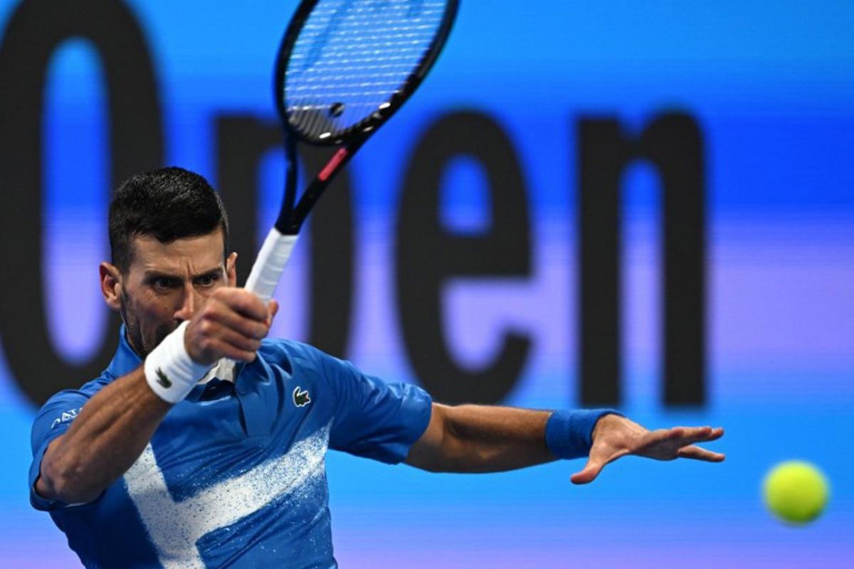 Serbia's Novak Djokovic hits a return to Italy's Matteo Berettini during their men's singles match at the ATP Qatar Open tennis tournament in Doha on February 18, 2025. Mahmud HAMS / AFP