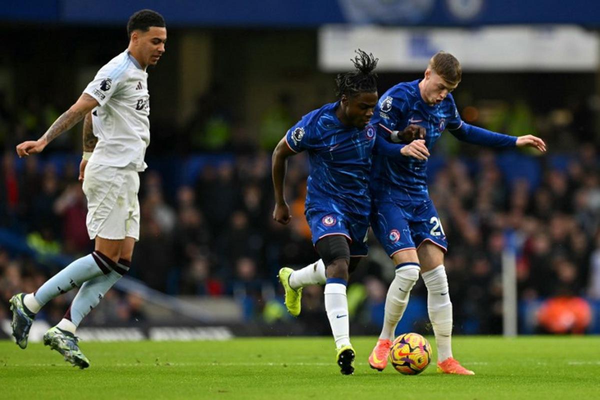 Chelsea's Belgian midfielder #45 Romeo Lavia and Chelsea's English midfielder #20 Cole Palmer (R) collide during the English Premier League football match between Chelsea and Aston Villa at Stamford Bridge in London on December 1, 2024. Glyn KIRK / AFP