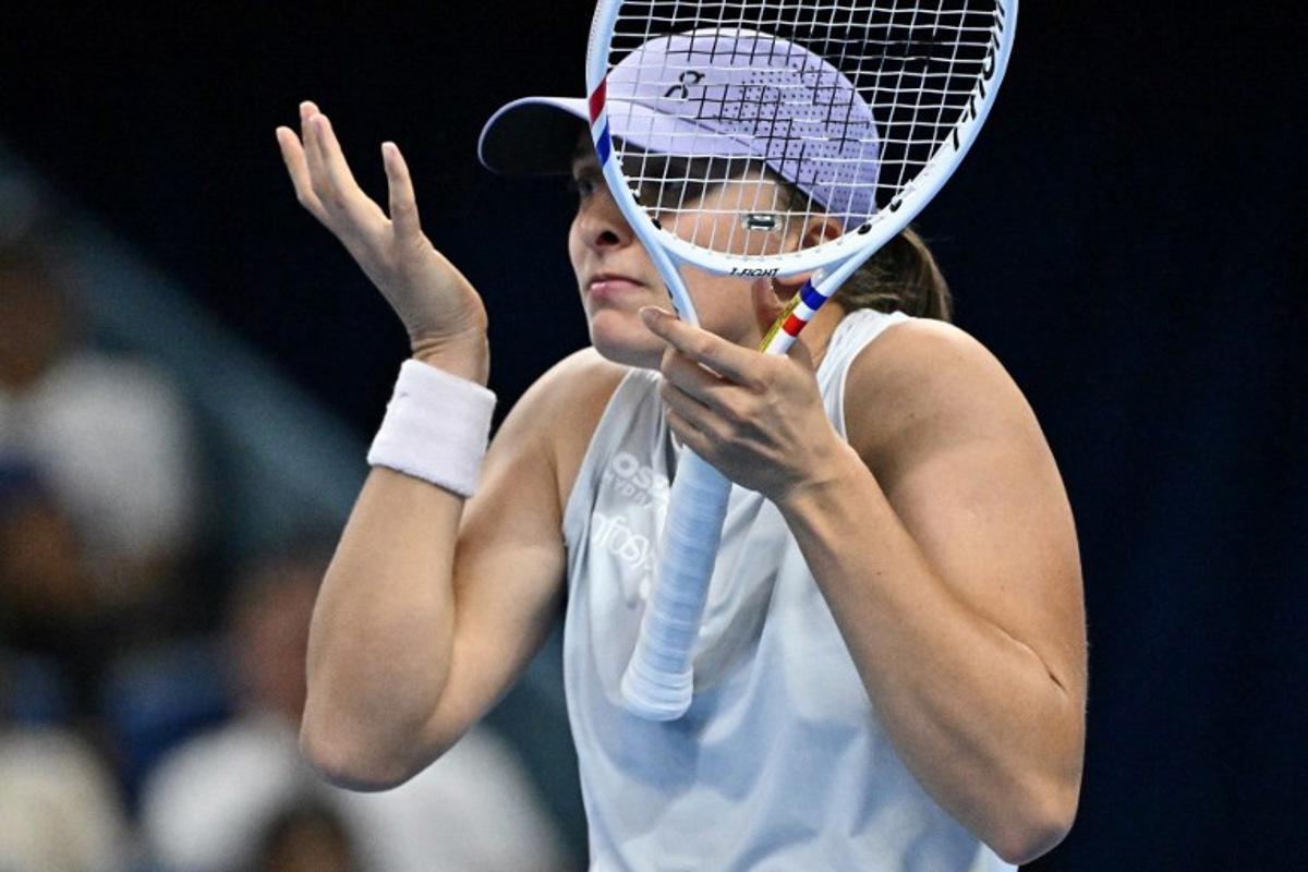 Poland's Iga Swiatek reacts during her women's singles match against USA's Emma Navarro at the China Open tennis tournament in Beijing on October 1, 2025. Pedro Pardo / AFP