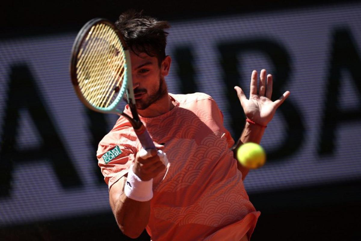 Argentina's Mariano Navone plays a forehand return to Italy's Lorenzo Musetti during their men's singles match on day 6 of the French Open tennis tournament on Court Suzanne-Lenglen at the Roland-Garros Complex in Paris on May 30, 2025. Anne-Christine POUJOULAT / AFP