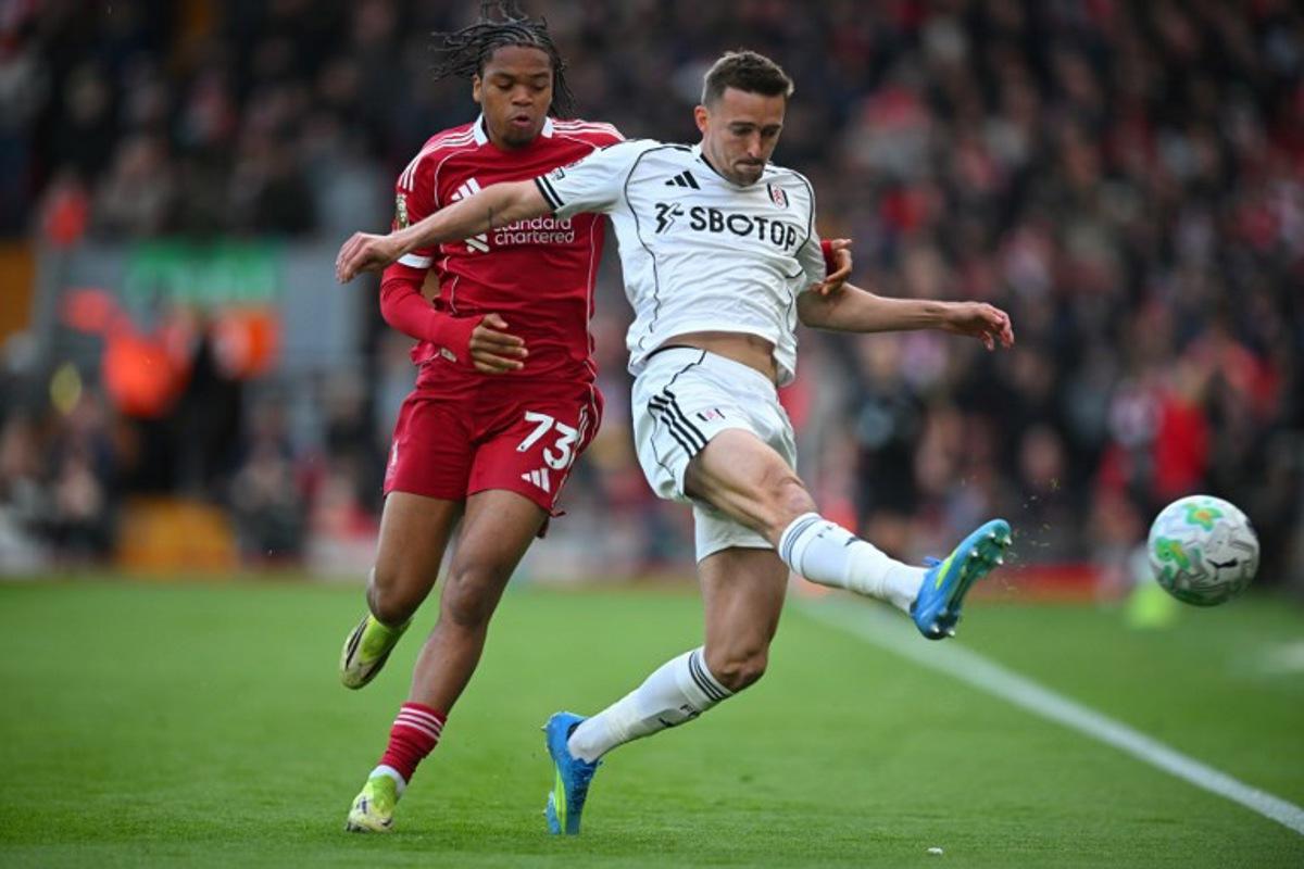 Fulham's Belgian defender #21 Timothy Castagne (R) vies with Liverpool's English striker #73 Rio Ngumoha (L) during the English Premier League football match between Liverpool and Fulham at Anfield in Liverpool, north west England on April 11, 2026. ANDY BUCHANAN / AFP