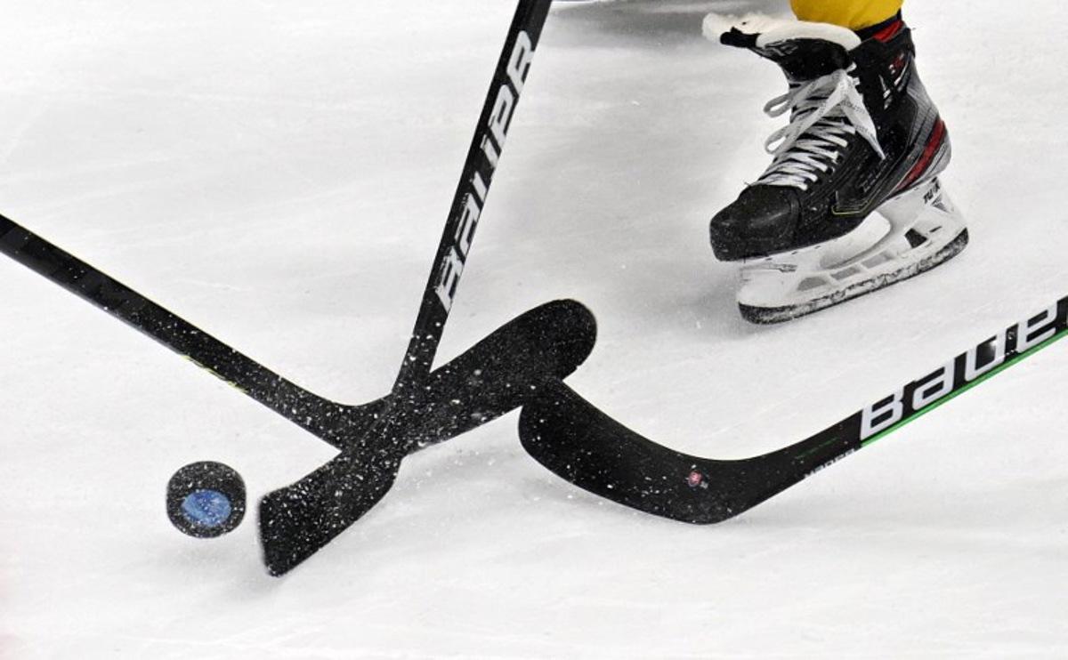 Players vie for the puck during the men's bronze medal match of the Beijing 2022 Winter Olympic Games ice hockey competition between Sweden and Slovakia, at the National Indoor Stadium in Beijing on February 19, 2022. GABRIEL BOUYS / AFP