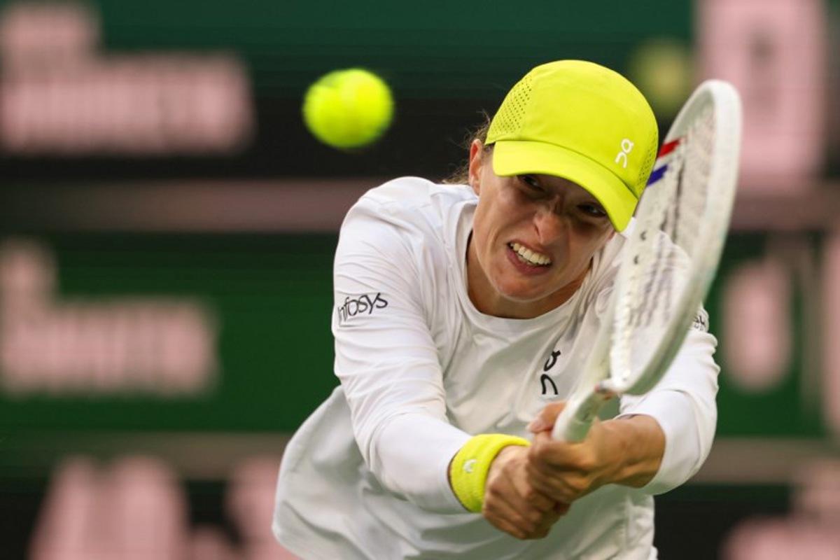 Poland's Iga Swiatek returns the ball to Russia's Mirra Andreeva during a women's singles semi-final tennis match at the BNP Paribas Open at the Indian Wells Tennis Garden in Indian Wells, California, on March 14, 2025. Patrick T. Fallon / AFP
