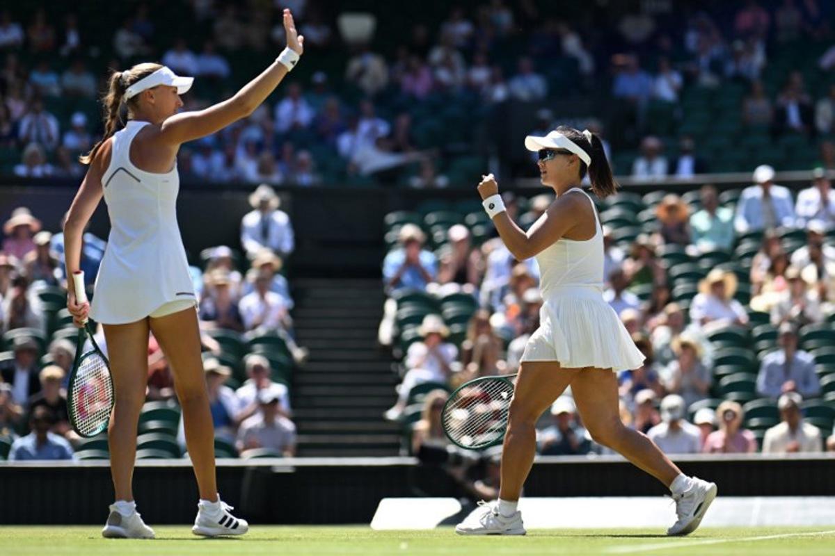 China's Guo Hanyu (R) and France's Kristina Mladenovic celebrate winning a point against Brazil's Luisa Stefani and Canada's Gabriela Dabrowski during their women's doubles final tennis match on the fourteenth day of the 2026 Wimbledon Championships at The All England Lawn Tennis and Croquet Club in Wimbledon, southwest London, on July 12, 2026. Kirill KUDRYAVTSEV / AFP
