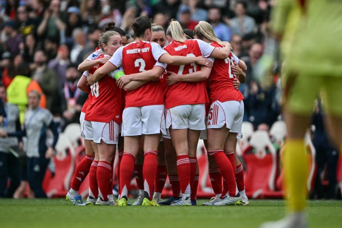 Arsenal players huddle to celebrate their first goal to draw even during the women's UEFA Champions League first-leg semi-final football match between Arsenal and OL Lyonnes at the Emirates Stadium, north London, on April 26, 2026. Glyn KIRK / AFP