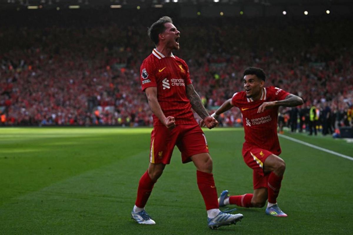 Liverpool's Argentinian midfielder #10 Alexis Mac Allister (L) celebrates with Liverpool's Colombian midfielder #07 Luis Diaz (R) after scoring their second goal during the English Premier League football match between Liverpool and Tottenham Hotspur at Anfield in Liverpool, north west England on April 27, 2025. Paul ELLIS / AFP