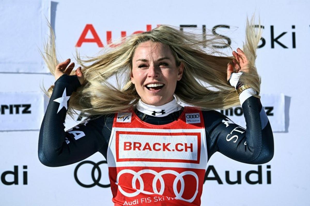 First-placed US Lindsey Vonn celebrates on the podium after competing in the women's downhill race during the FIS Alpine Ski World Cup 2025-2026, in St Moritz, south-eastern Switzerland on December 12, 2025. Fabrice COFFRINI / AFP