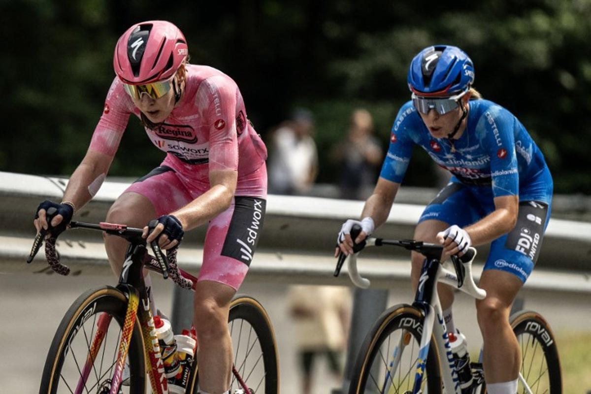 SD Worx Dutch rider Anna Van Der Breggen wearing the overall leader's pink jersey (Maglia Rosa) and FDJ SUEZ Dutch rider Demi Vollering wearing the best climber's blue jersey (Maglia Azzura) ride during the 9th stage of the Giro d'Italia Women 2026 - Tour of Italy Women cycling race between Saluzzo and Saluzzo, Italy, on June 7, 2026. MARCO BERTORELLO / AFP
