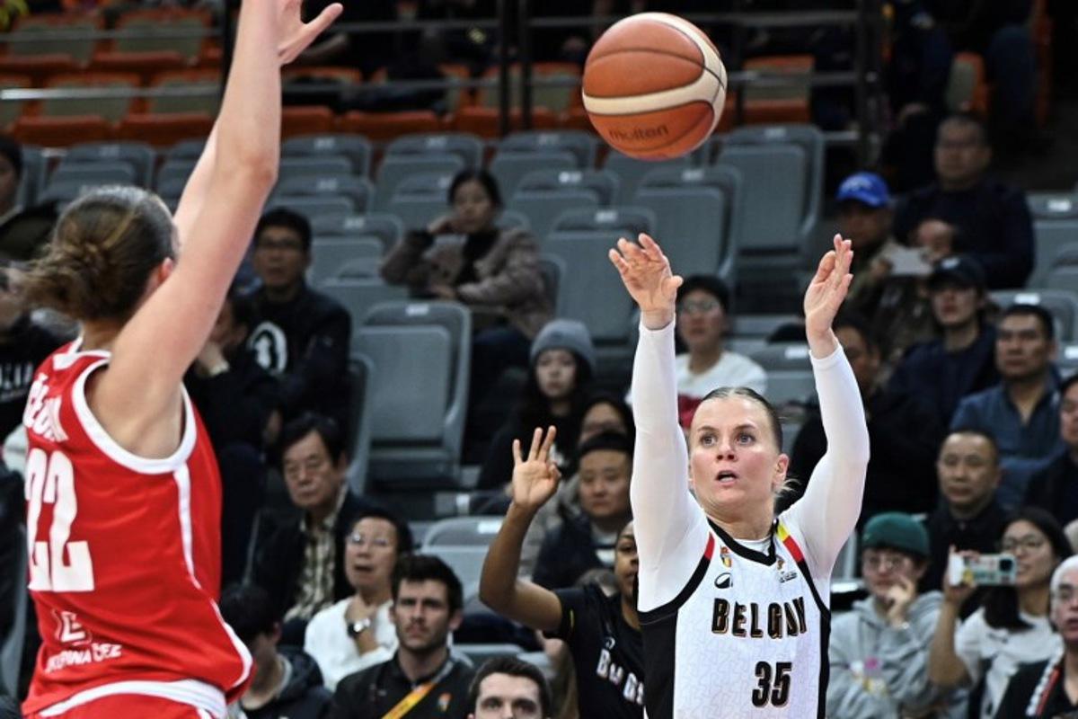 Belgium´s Julie Vanloo (R) shoots under the pressure of Czech Republic´s Emma Cechova during the FIBA Women's Basketball World Cup 2026 qualifying tournament game between Belgium and Czech Republic in Wuhan, in China's central Hubei province on March 17, 2026. CN-STR / AFP