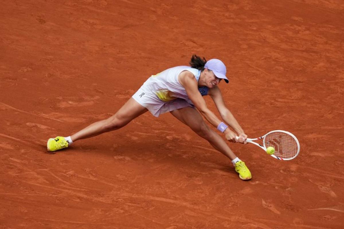 Poland's Iga Swiatek plays a backhand return to Kazakhstan's Elena Rybakina during their women's singles match on day 8 of the French Open tennis tournament on Court Philippe-Chatrier at the Roland-Garros Complex in Paris on June 1, 2025. Dimitar DILKOFF / AFP