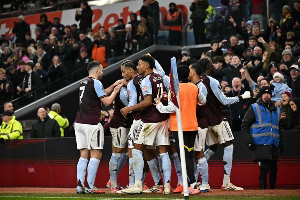 Aston Villa's English midfielder #27 Morgan Rogers celebrates with team-mates after scoring his team's first goal to take the lead 1-0 during the English Premier League football match between Aston Villa and Manchester United at Villa Park in Birmingham, central England on December 21, 2025. Ben STANSALL / AFP