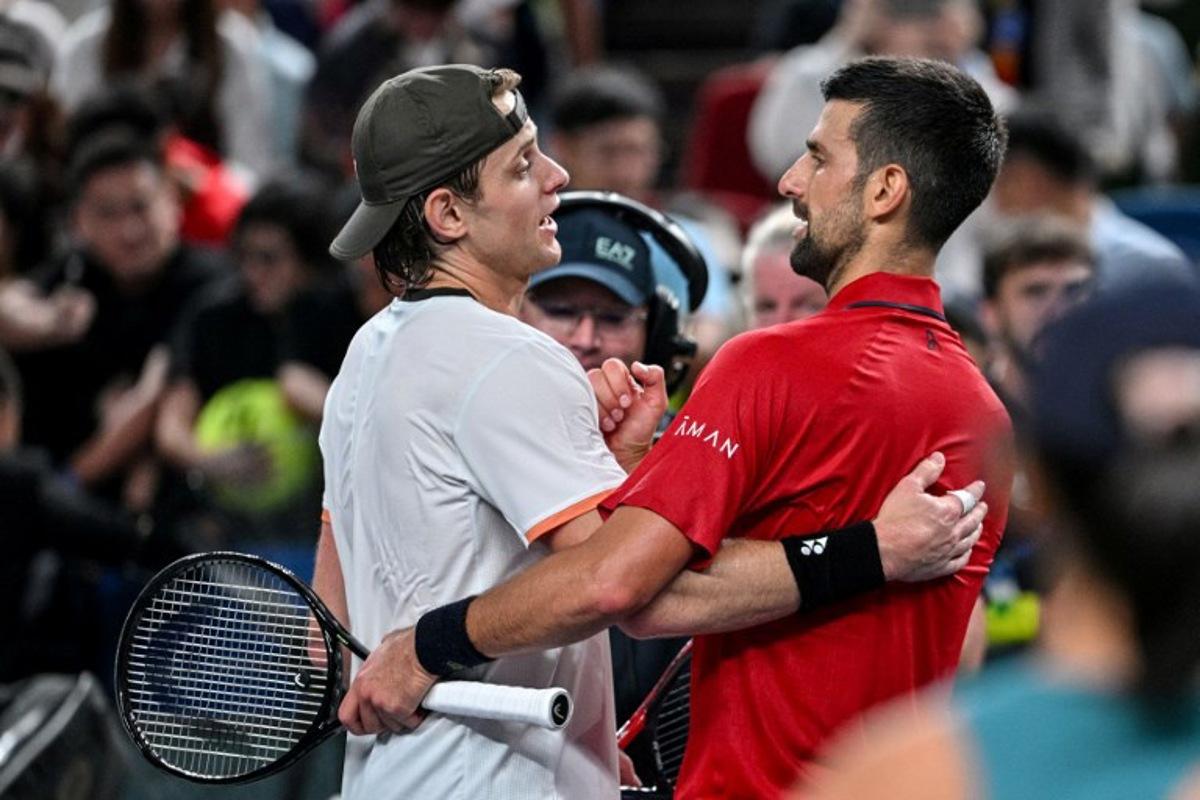 Serbia's Novak Djokovic (R) shakes hands with Belgium's Zizou Bergs at the end of their quarter-final men's singles match at the Shanghai Masters tennis tournament in Shanghai on October 9, 2025. Hector RETAMAL / AFP