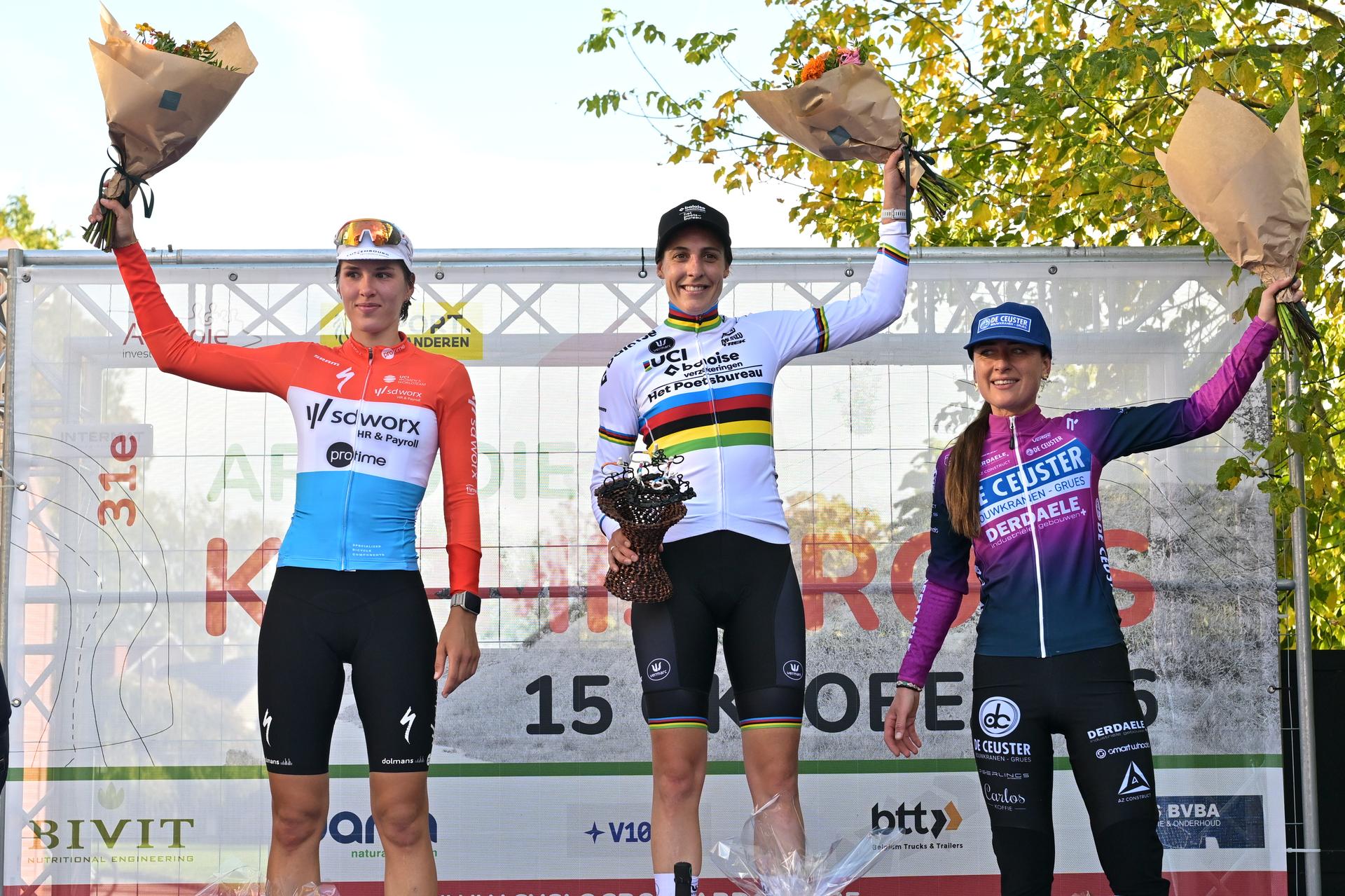 Luxembourg's Marie Schreiber; Netherlands' Lucinda Brand and Netherlands' Denise Betsema celebrate on the podium after the women elite race of the 'Kermiscross' cyclocross cycling event, on Thursday 15 October 2026, in Ardooie. BELGA PHOTO DAVID PINTENS