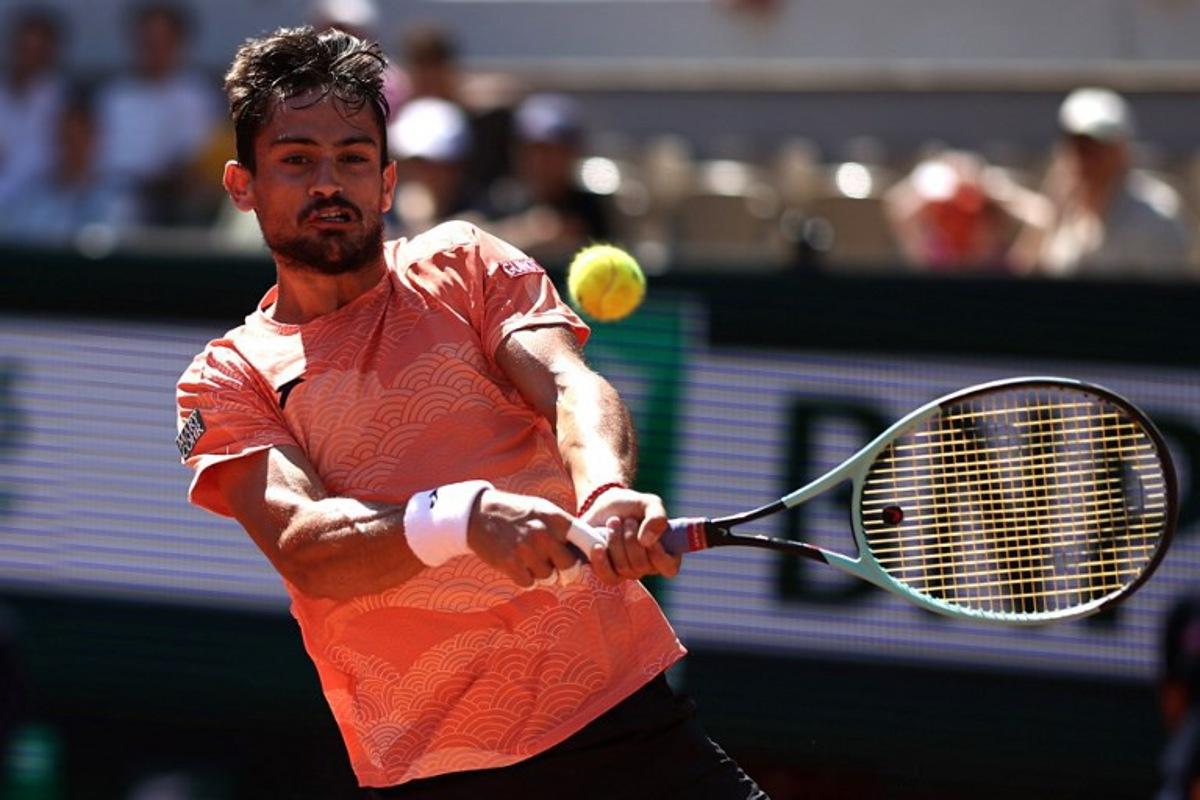 Argentina's Mariano Navone plays a backhand return to Italy's Lorenzo Musetti during their men's singles match on day 6 of the French Open tennis tournament on Court Suzanne-Lenglen at the Roland-Garros Complex in Paris on May 30, 2025. Anne-Christine POUJOULAT / AFP