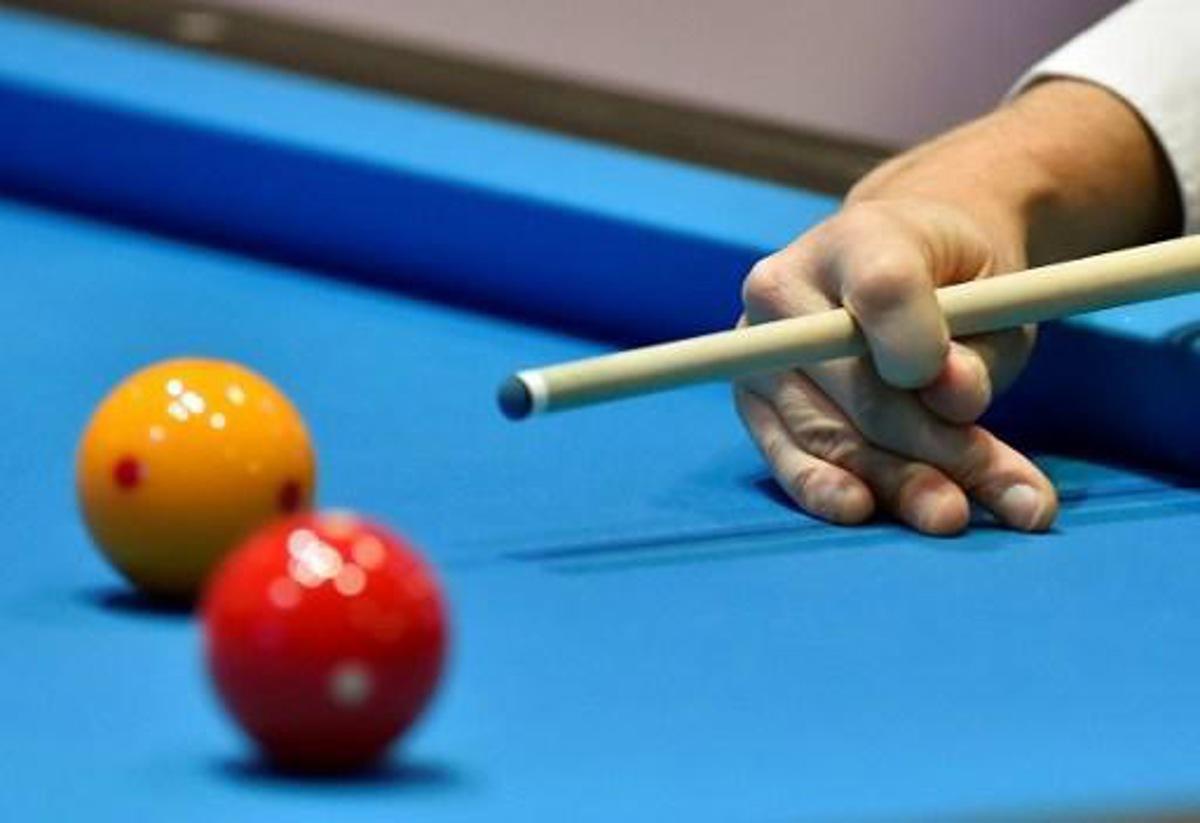 A player competes in the qualification round of the 3-Cushion Billiards World Championship in Bordeaux on November 15, 2016.
GEORGES GOBET / AFP