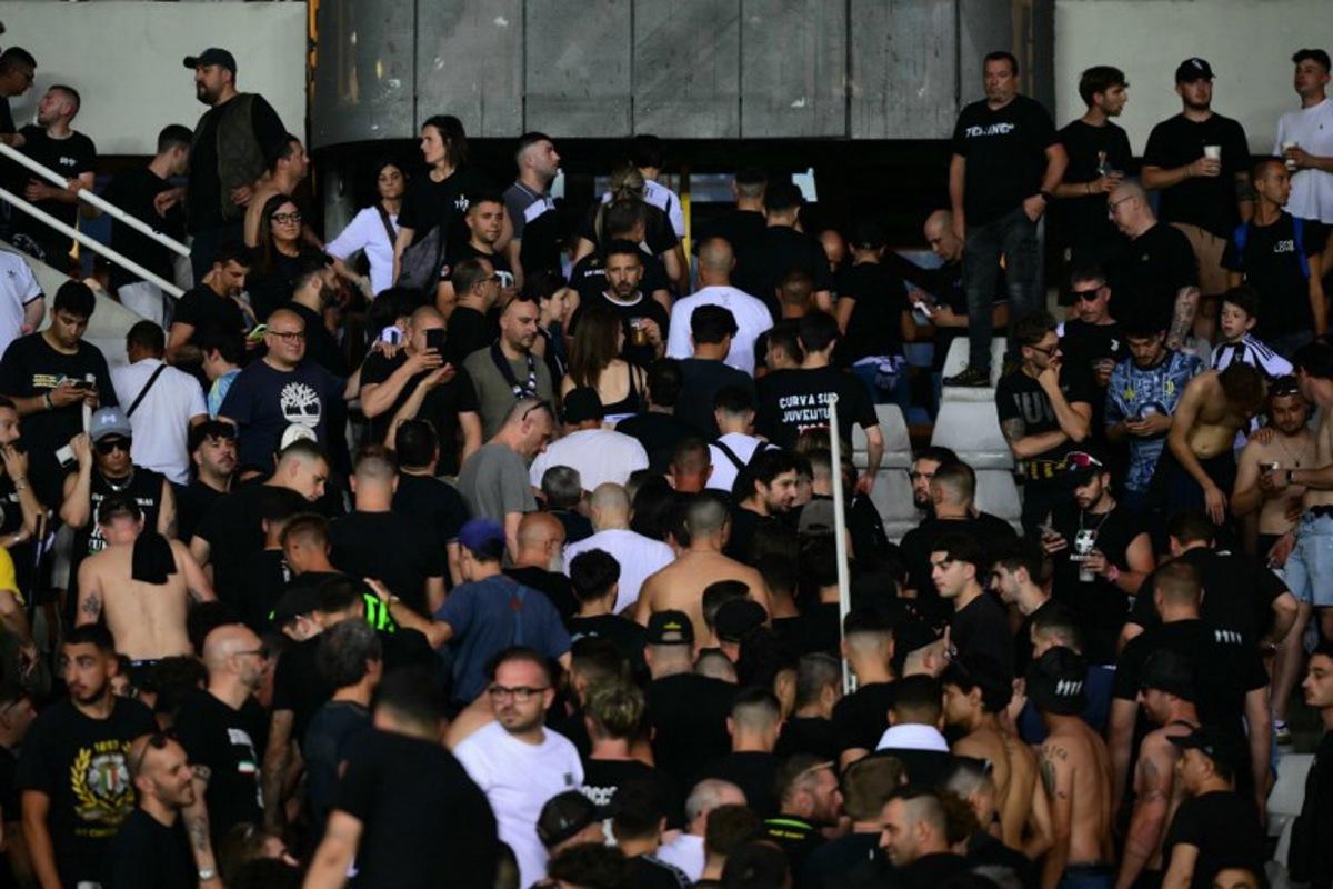 Juventus' supporters leave the stadium after a suspension of the Italian Serie A football match betweem Torino and Juventus FC at the Olympic Stadium Grande Torino in Turin on May 24, 2026. MARCO BERTORELLO / AFP