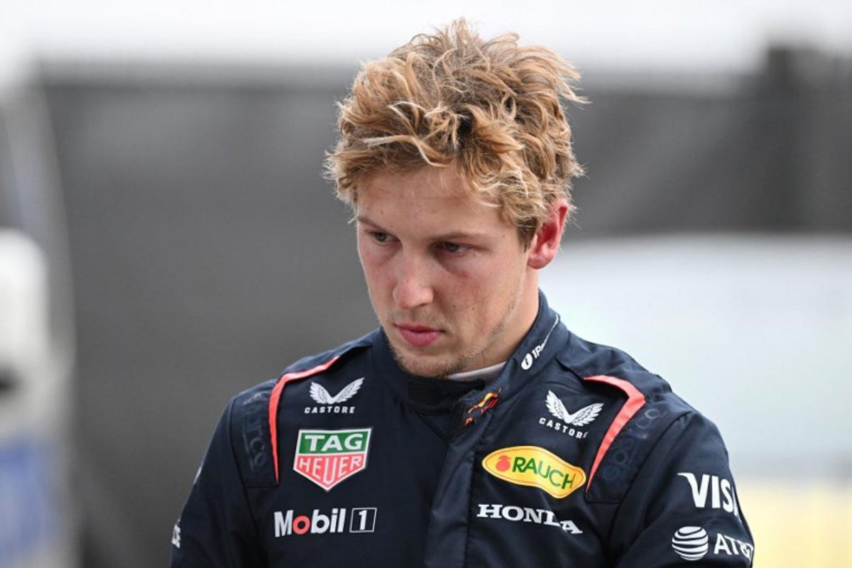 Red Bull Racing's New Zealand driver Liam Lawson walks back to his team garage after getting out of his car at the end of the Formula One Chinese Grand Prix in Shanghai on March 23, 2025. GREG BAKER / AFP