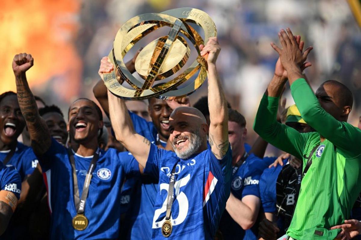 Chelsea's Italian head coach Enzo Maresca lifts the trophy with teammates during the award ceremony for the FIFA Club World Cup 2025 Champions, following the final football match between England's Chelsea and France's Paris Saint-Germain at the MetLife Stadium in East Rutherford, New Jersey on July 13, 2025. ANGELA WEISS / AFP