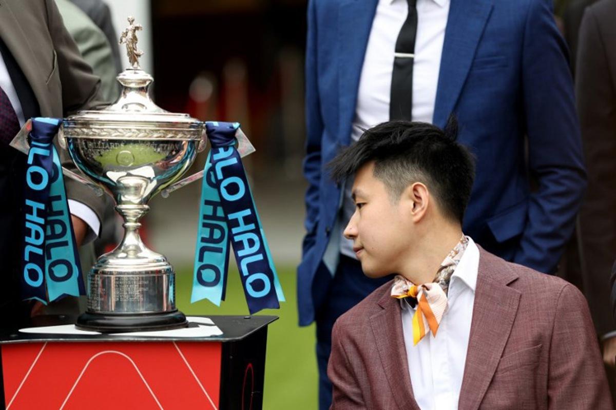 Chinese snooker player Zhao Xintong looks at the trophy during a media day launching the start of the World Snooker Championship 2026 at Crucible Theatre in Sheffield, northern England, on April 17, 2026. Darren Staples / AFP