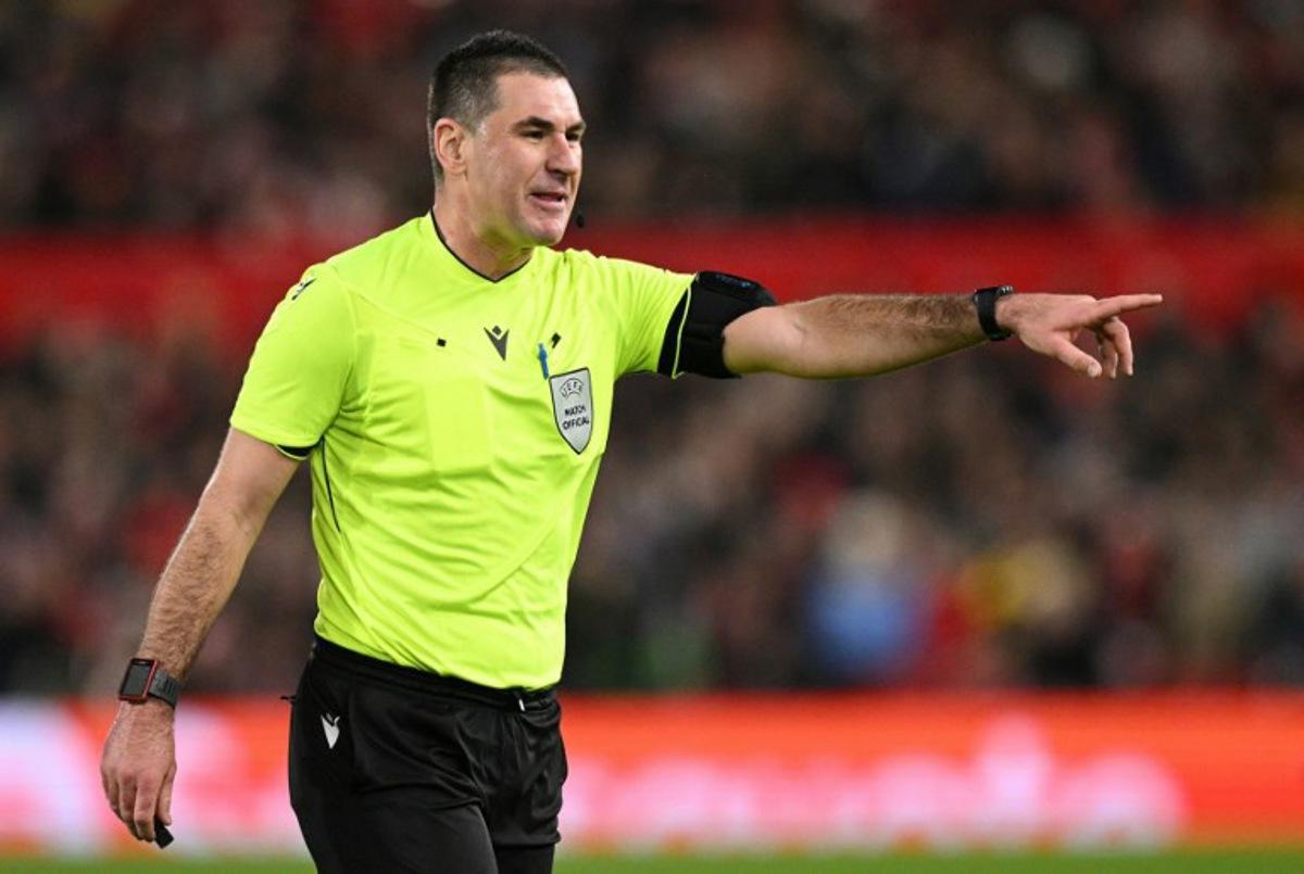 Slovenian referee Rade Obrenovic gestures during the UEFA Europa League round of 16, first leg football match between Nottingham Forest and FC Midtjylland at The City Ground in Nottingham, central England, on March 12, 2026. Oli SCARFF / AFP