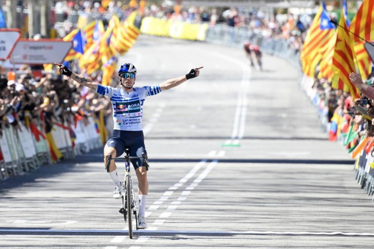 Team Bora's Primoz Roglic celebrates as he crosses the finish line to win the 7th and final stage of the 2025 Volta a Catalunya cycling tour of Catalonia race, a 88,2 km loop between Barcelona and Barcelona, on March 30, 2025. Roglic won the Vuelta a Catalunya on Sunday, soloing through the seventh and final stage in Barcelona, where his main rival Juan Ayuso (UAE) fell behind in the final. Roglic, who was a second behind Ayuso at the start of this final stage, broke away with 20 km to go and managed to maintain his lead to secure his second Volta a Catalunya victory. Josep LAGO / AFP