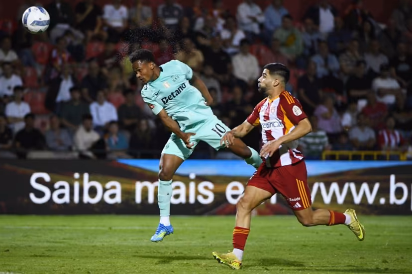 Sporting Lisbon's Mozambican forward #10 Geny Catamo heads the ball next to AVS' Nigerian forward #11 Tunde Akinsola during the Portuguese League football match between AVS Futebol SAD and Sporting CP at CD Aves stadium in Vila das Aves on April 26, 2026. MIGUEL LEMOS / AFP