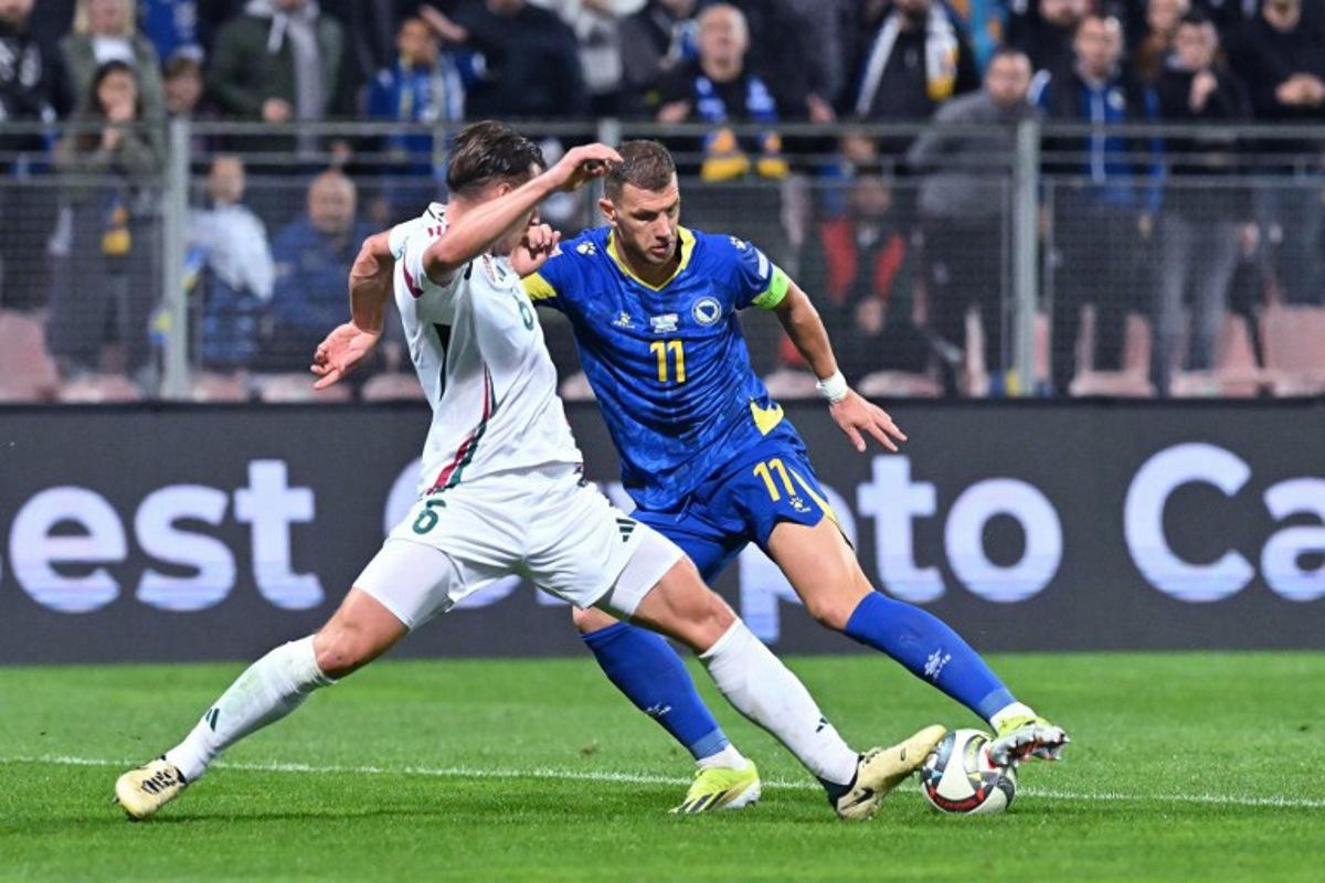 Bosnia and Herzegovina's forward #11 Edin Dzeko (R) fights for the ball with Hungary's defender #06 Willi Orban during the UEFA Nations League, League A - Group 3, football match between Bosnia and Herzegovina and Hungary at the Bilino Polje Stadium in Zenica, in Zenica, on October 14, 2024. Elvis Barukcic / AFP