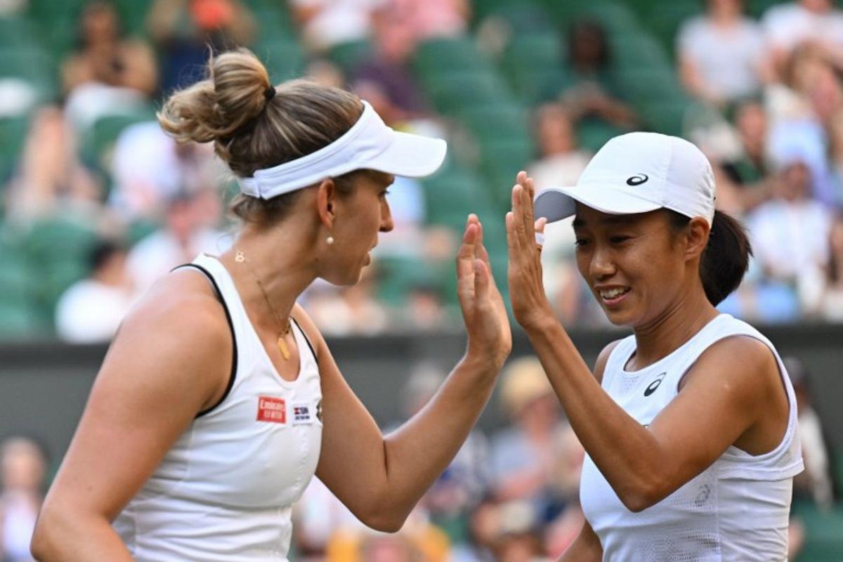 Belgium's Elise Mertens (L) and China's Zhang Shuai play against Czech Republic's Barbora Krejcikova and Czech Republic's Katerina Siniakova during their women's doubles final tennis match on the fourteenth day of the 2022 Wimbledon Championships at The All England Tennis Club in Wimbledon, southwest London, on July 10, 2022. SEBASTIEN BOZON / AFP
