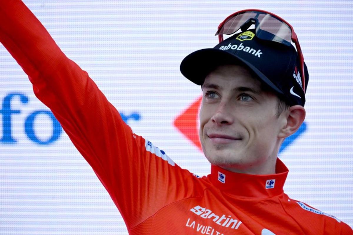 Overall race leader red jersey holder team Visma-Lease a bike's Danish rider Jonas Vingegaard celebrates on the podium of the 19th stage of the Vuelta a Espana, a 159 km race between Rueda and Guijuelo, on September 12, 2025. Miguel RIOPA / AFP