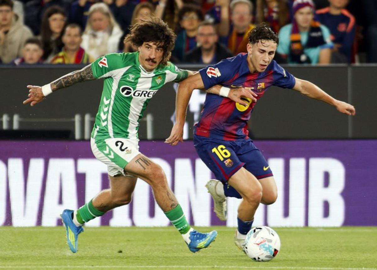 Real Betis' Spanish defender #02 Hector Bellerin and Barcelona's Spanish midfielder #16 Fermin Lopez fight for the ball during the Spanish league football match between FC Barcelona and Real Betis at the Camp Nou Stadium in Barcelona on May 17, 2026. JAIME REINA / AFP