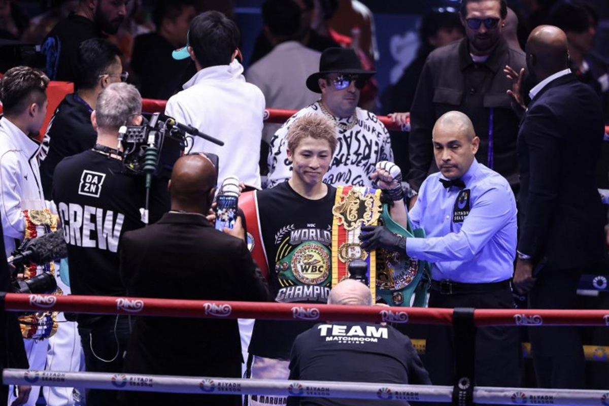 Japan's boxer Naoya Inoue celebrates with the winner's belt after beating Mexico's boxer David Picasso in the "The Ring V night of Samurai" final major fight card of the year at the Mohammed Abdo Arena in Riyadh on December 27, 2025. Fayez NURELDINE / AFP