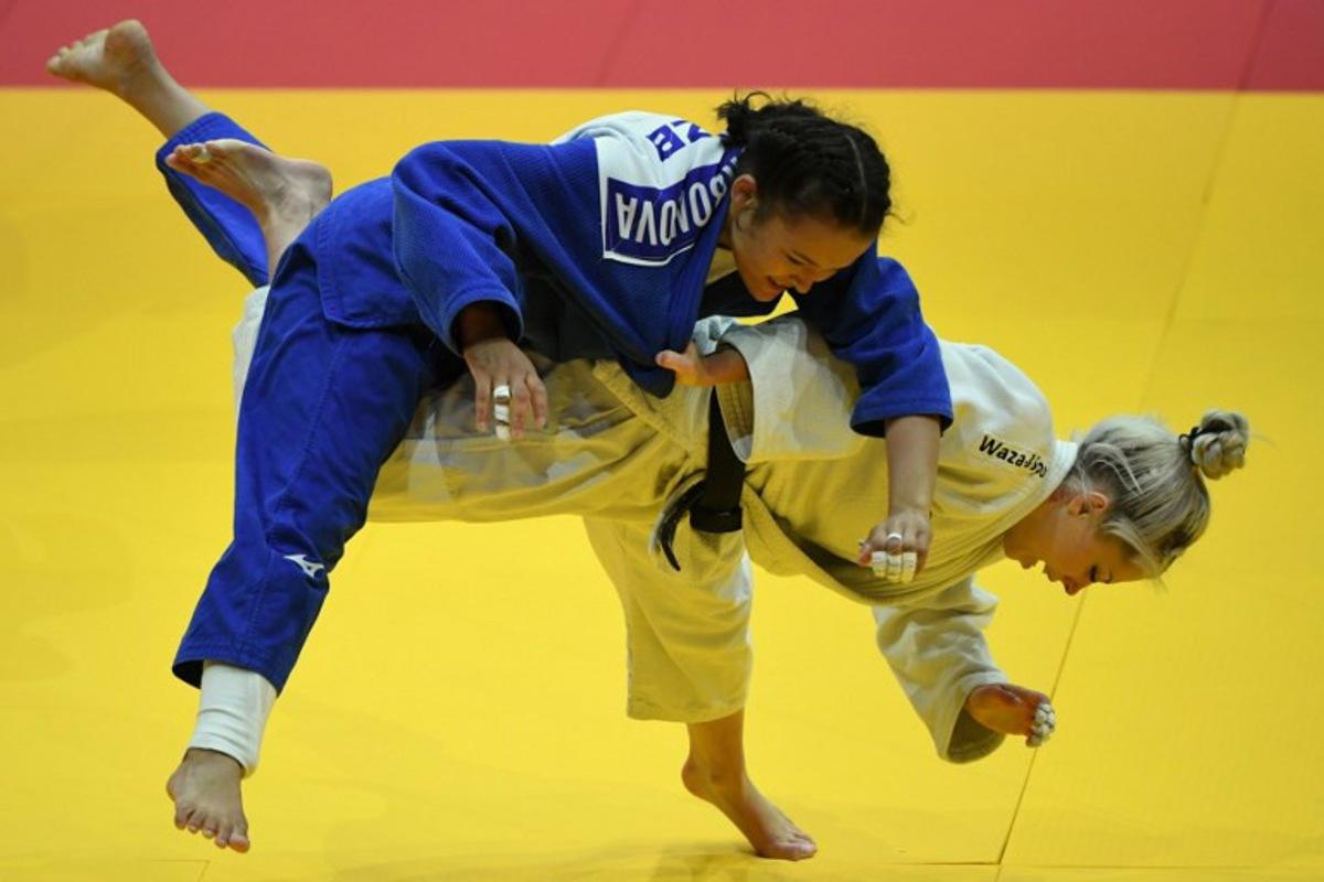 Belgium's Lois Petit competes against Uzbekistan's Khalimajon Kurbonova (blue) in the women's -48kgs qualification round bout of the Judo World Championships in Budapest, Hungary, on June 13, 2025. Ferenc ISZA / AFP