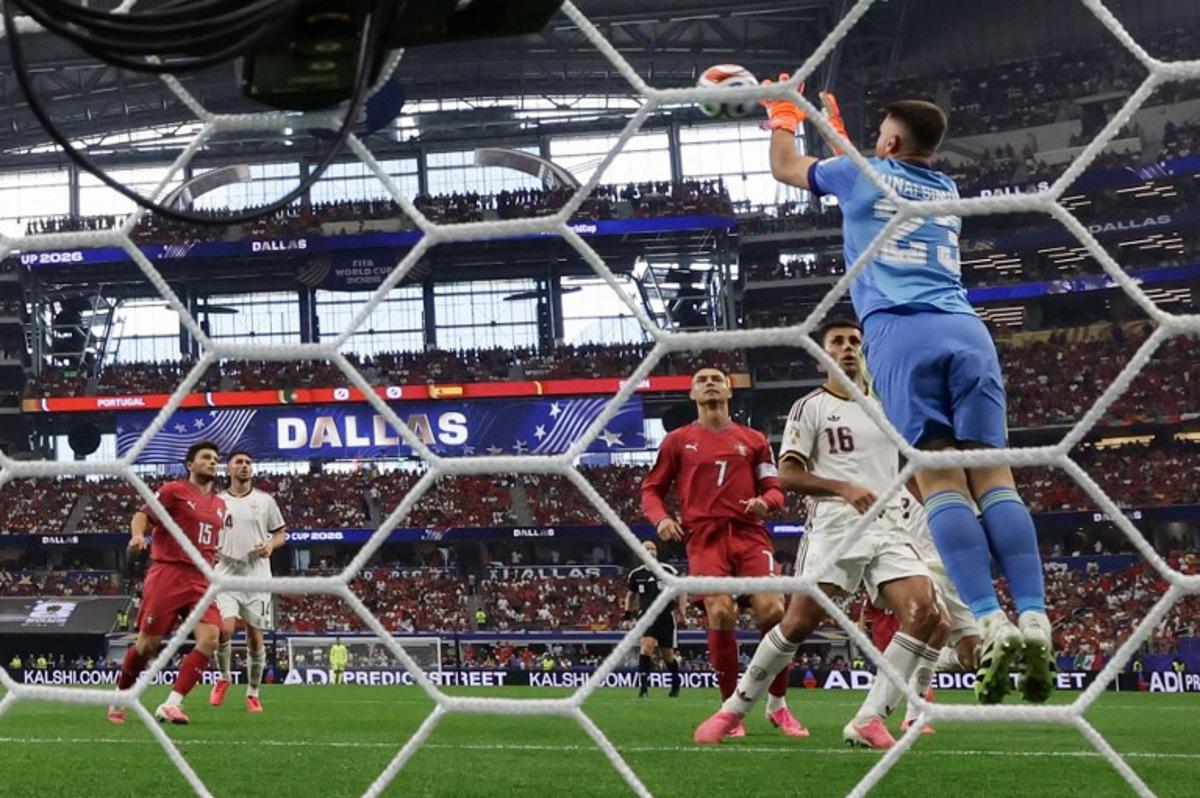 Spain's goalkeeper #23 Unai Simon grabs the ball past Portugal's forward #07 Cristiano Ronaldo during the 2026 World Cup round of 16 football match between Portugal and Spain at the Dallas Stadium in Arlington on July 6, 2026. Aric Becker / AFP