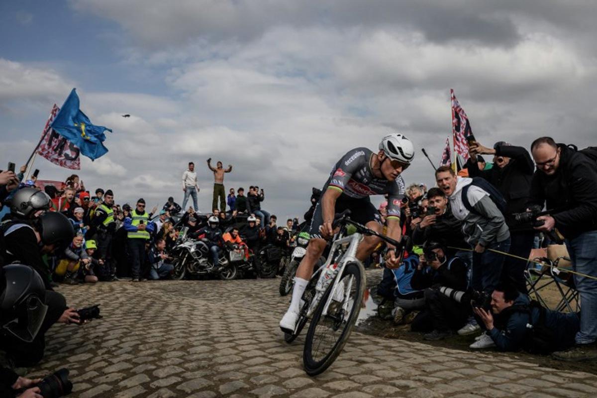 Alpecin-Deceuninck's Dutch rider Mathieu van der Poel cycles in a breakaway leading the race at the Carrefour de l'Arbre, a cobblestone road, during the 122nd edition of the Paris-Roubaix one-day classic cycling race, 259,2 km between Compiegne and Roubaix, northern France on April 13, 2025. JEFF PACHOUD / AFP