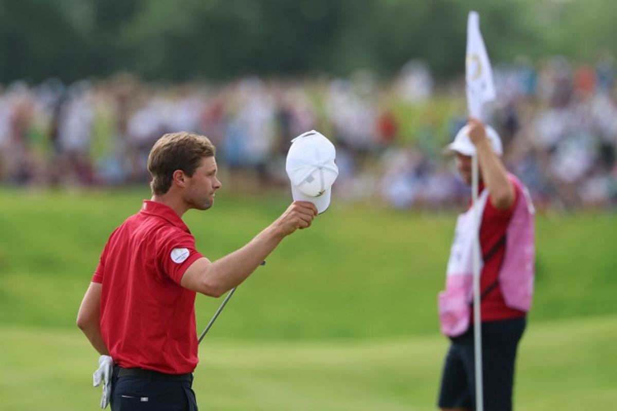 Belgium's Thomas Detry gestures after completing the course in round 4 of the men's golf individual stroke play of the Paris 2024 Olympic Games at Le Golf National in Guyancourt, south-west of Paris on August 4, 2024. Emmanuel DUNAND / AFP