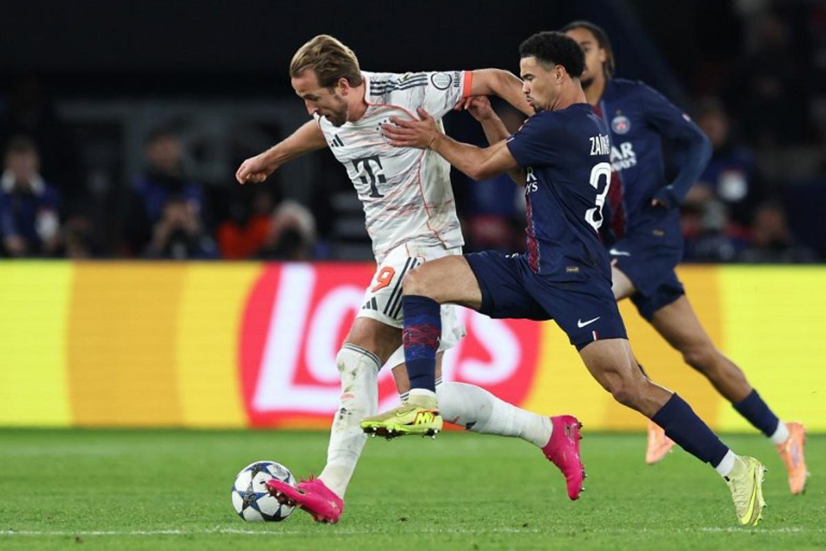 Bayern Munich's English forward #09 Harry Kane (L) fights for the ball with Paris Saint-Germain's French midfielder #33 Warren Zaire-Emery during the UEFA Champions League, league phase day 4, football match between Paris Saint-Germain (PSG) and FC Bayern Munich at the Parc des Princes in Paris, on November 4, 2025. Thomas SAMSON / AFP